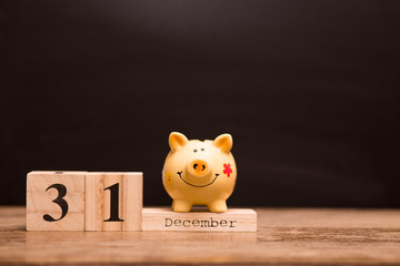 Calendar date for End of Financial Year, 31 december with piggy bank on dark background