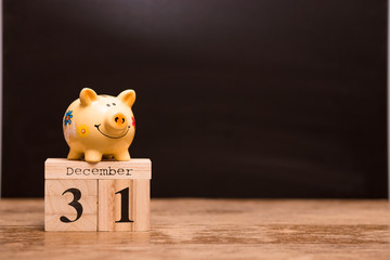Calendar date for End of Financial Year, 31 december with piggy bank on dark background