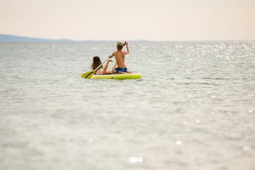 young couple on the stand up paddle board