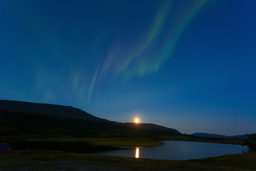 Naklejka na ściany i meble Aurora in the night sky cut the mountains, reflected in the water. Yamal. Russia