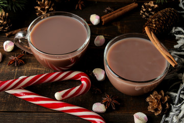 Obraz na płótnie Canvas hot cocoa in a glass cup on a brown wooden background. Winter. new Year. Christmas. tree gifts