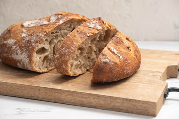 sliced bread on a wooden board close-up, homemade product
