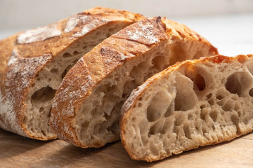 sliced bread on a wooden board close-up, homemade product