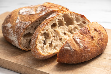 sliced bread on a wooden board close-up, homemade product