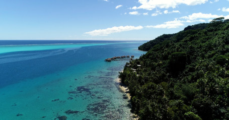bungalow on the water in aerial view, french polynesia