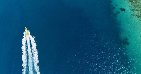 boat in a lagoon in French Polynesia, in aerial view