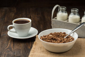 Healthy breakfast fresh cereal, milk bottle, coffee cup.