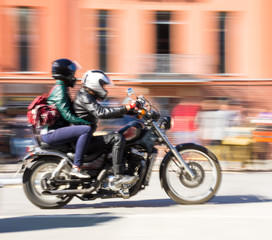 Bikers riding motorcycle at sunny day