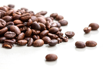 Roasted coffee beans isolated on a white background.