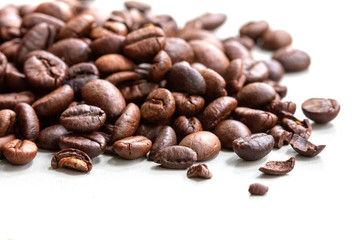 Roasted coffee beans isolated on a white background.