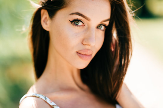 Closeup lifestyle portrait of celebrity female model.  Beautiful girl face on abstract nature background. Cheerful amazing young woman face expression. Sexy blue eyed babe. Glamour youth appearance.