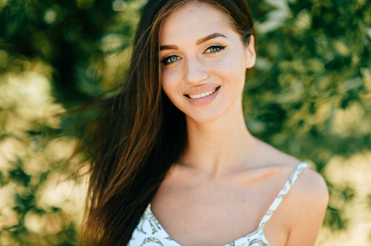 Closeup lifestyle portrait of celebrity female model.  Beautiful girl face on abstract nature background. Cheerful amazing young woman face expression. Sexy blue eyed babe. Glamour youth appearance.