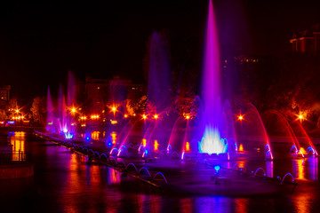 Naklejka na ściany i meble Glowing multicolored illumination fountains in the Far Eastern city of Khabarovsk.