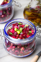 Vinaigrette salad with olive (vegetable) oil in a jar. Selective focus, close-up.