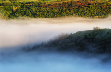 fog in the canyon of a picturesque river. spring morning
