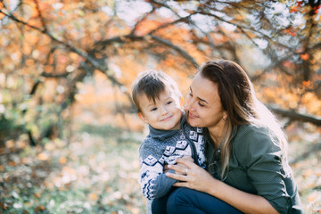 mother with son three years in autumn the forest, embrace and tenderness