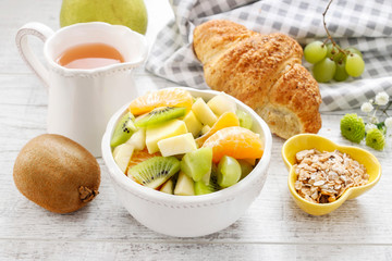 Bowl of fruit salad and jug of juice.