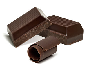 Chocolate curls and chocolate bars, chips or pieces isolated on white background