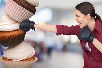 Fit young woman fighting off fast food