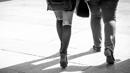 Obraz premium the leg of a young girl with sexy socks with church elements in black and white street photography. sexy pantyhose in urban environment