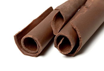 Dark chocolate curls isolated on white background