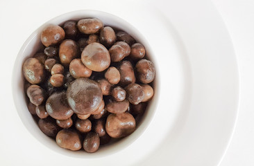boiled puff ball mushroom in small dish, isolated on white background with clipping path