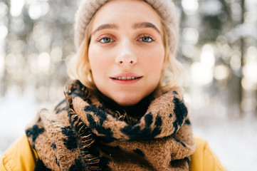 Adorable young beautiful girl lifestyle winter portrait. Pretty cute blue eyed female model outdoor. Sensual emotional face of amazing stylish woman. Cute hipster lady posing in fashionable clothes.