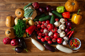Vegetables and nuts on a brown wooden background