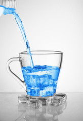 pouring water into a cup