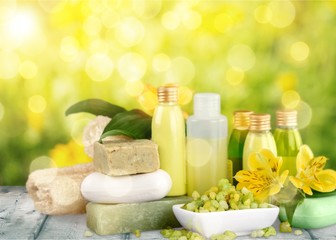 Bottles with organic essential aroma oils on background