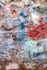 Old abstract red blue multi coloured painted brick wall background 