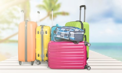 Retro suitcase with travel objects  on sea background