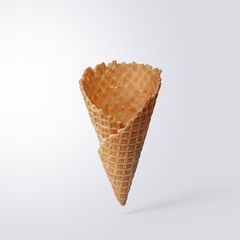 Wafer ice cream cone on a light gray background. Minimalistic concept.