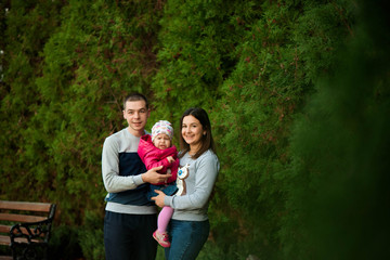 Family portrait, parents with daughter, autumn family portrait.