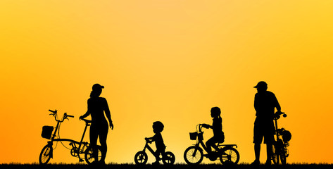 Fototapeta na wymiar silhouette family riding bicycle on blurry sunset