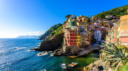 Fototapeta na wymiar Riomaggiore - Village of Cinque Terre National Park at Coast of Italy. Beautiful colors at sunset. Province of La Spezia, Liguria, in the north of Italy - Travel destination and attractions in Europe.