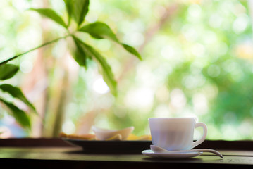 white coffee cup on wood table and bokhe back ground