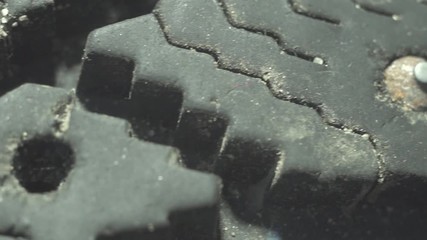 extremely close-up of a steel spike on an old tyre