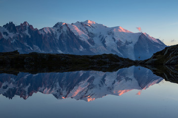 The Mont Blanc massif reflected in Lac de Chesery during dusk. Chamonix, France.