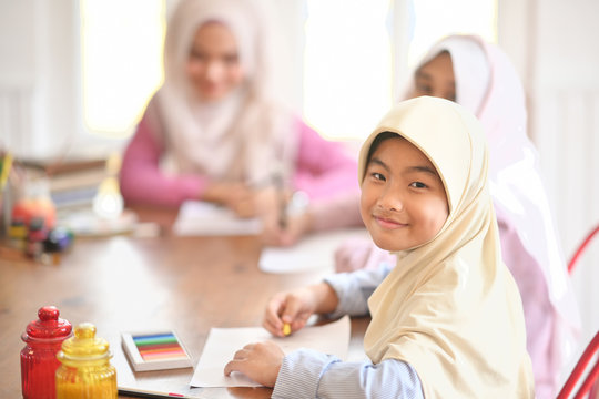 Young Asian Muslim Student Girls In Class.