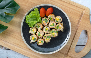 Gyoza filled with lean pork mince or chicken, finely shredded cabbage, carrot, ginger, sesame oil, soy bean, sugar, grilled on Takoyaki pan.