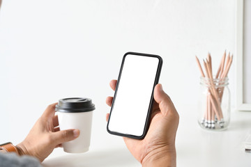 Businessman's hand using blank white screen mobile smart phone.