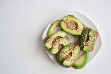 Sandwiches with avocado and grain bread, top view