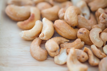 Cashew pile on wooden background