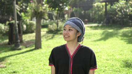 Asian ethnic woman with native dress smile at her organic rice field