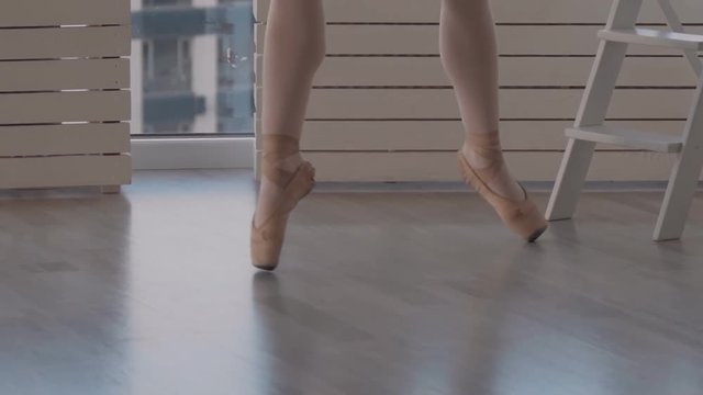 professional dancer on pointe doing rotation on a diagonal. close-up shot in slow motion. slowmotion