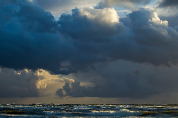 Beautiful evening clouds over the storming Bali Sea