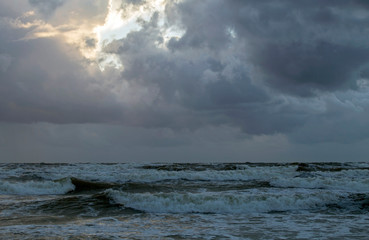 Beautiful evening clouds over the storming Bali Sea