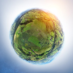 Globe panorama. stereographic projection of a green fields in mountain. 360 degree panorama. little...