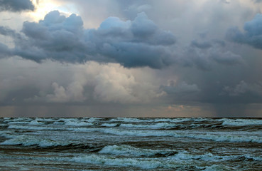 Beautiful evening clouds over the storming Bali Sea